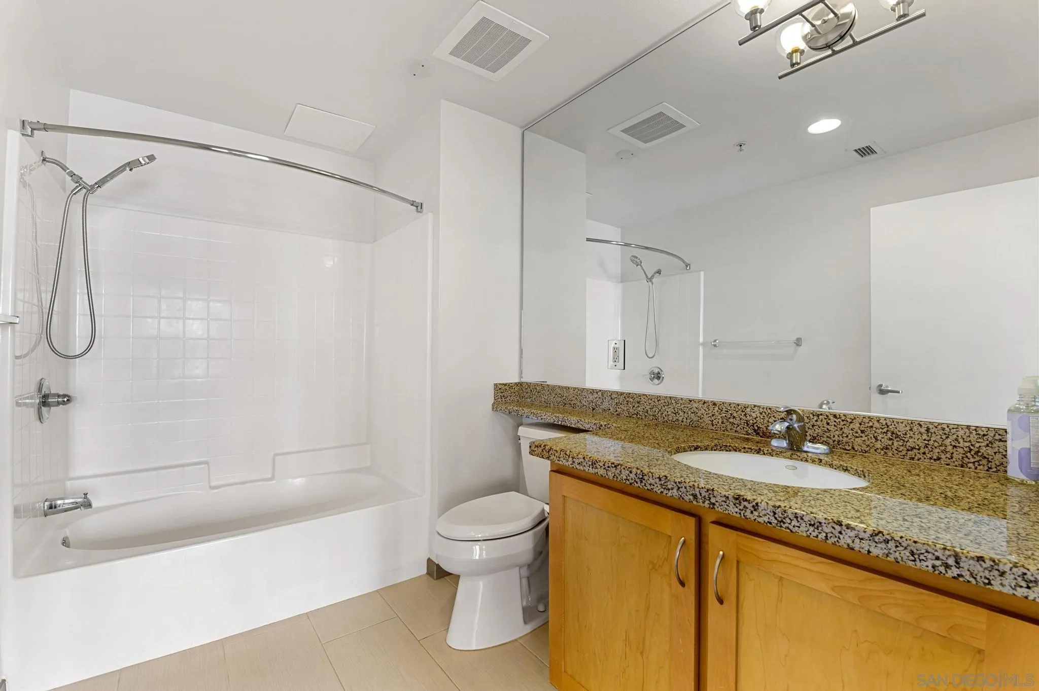 450 J Street, Unit 4121 San Diego, CA 92101 - Photo 13 of 22 a bathroom with a granite countertop sink toilet and shower