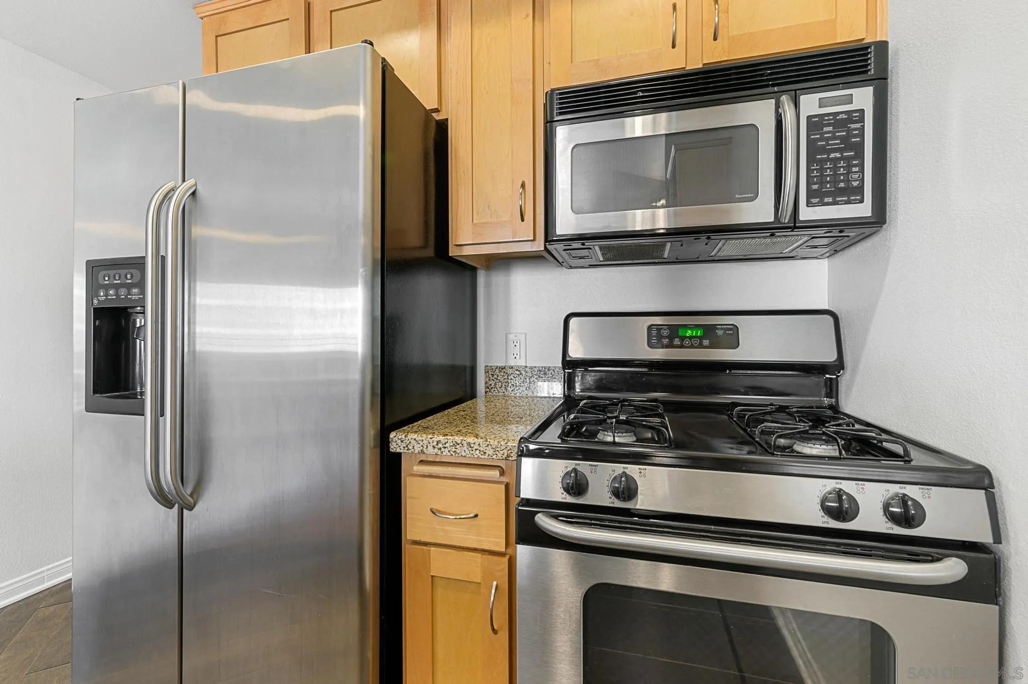 450 J Street, Unit 4121 San Diego, CA 92101 - Photo 6 of 22 a kitchen with stainless steel appliances granite countertop a stove microwave and refrigerator
