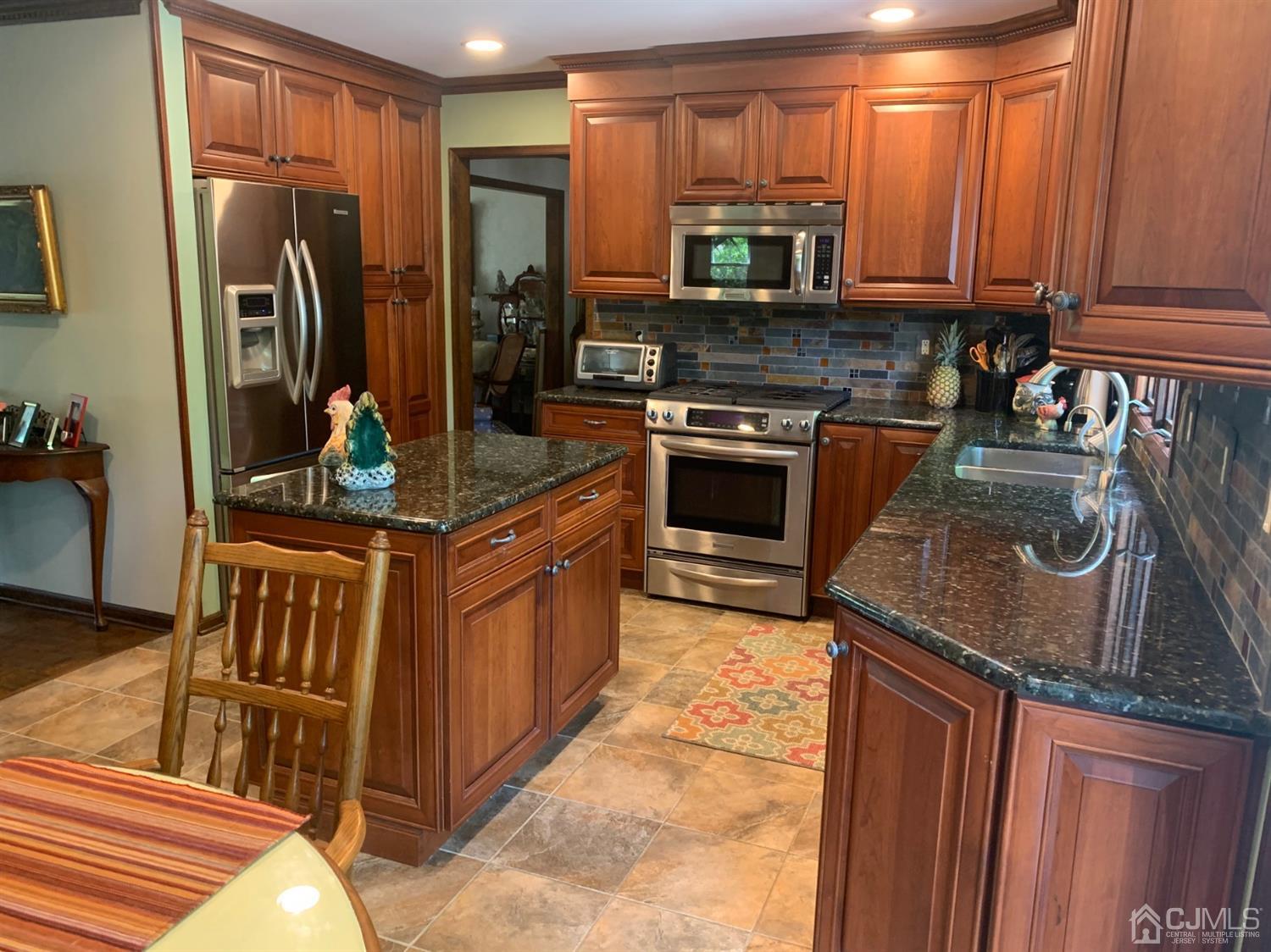 2 Fox Hill Road Edison, NJ 08820 - Photo 11 of 37 a kitchen with stainless steel appliances granite countertop a stove a sink and a microwave