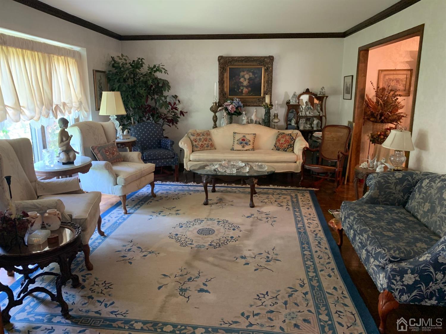 2 Fox Hill Road Edison, NJ 08820 - Photo 16 of 37 a living room with furniture and a large mirror next to a window