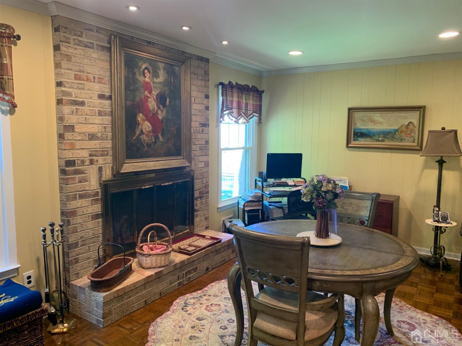 2 Fox Hill Road Edison, NJ 08820 - Photo 19 of 37 a dining room with furniture a flat screen tv and a fireplace