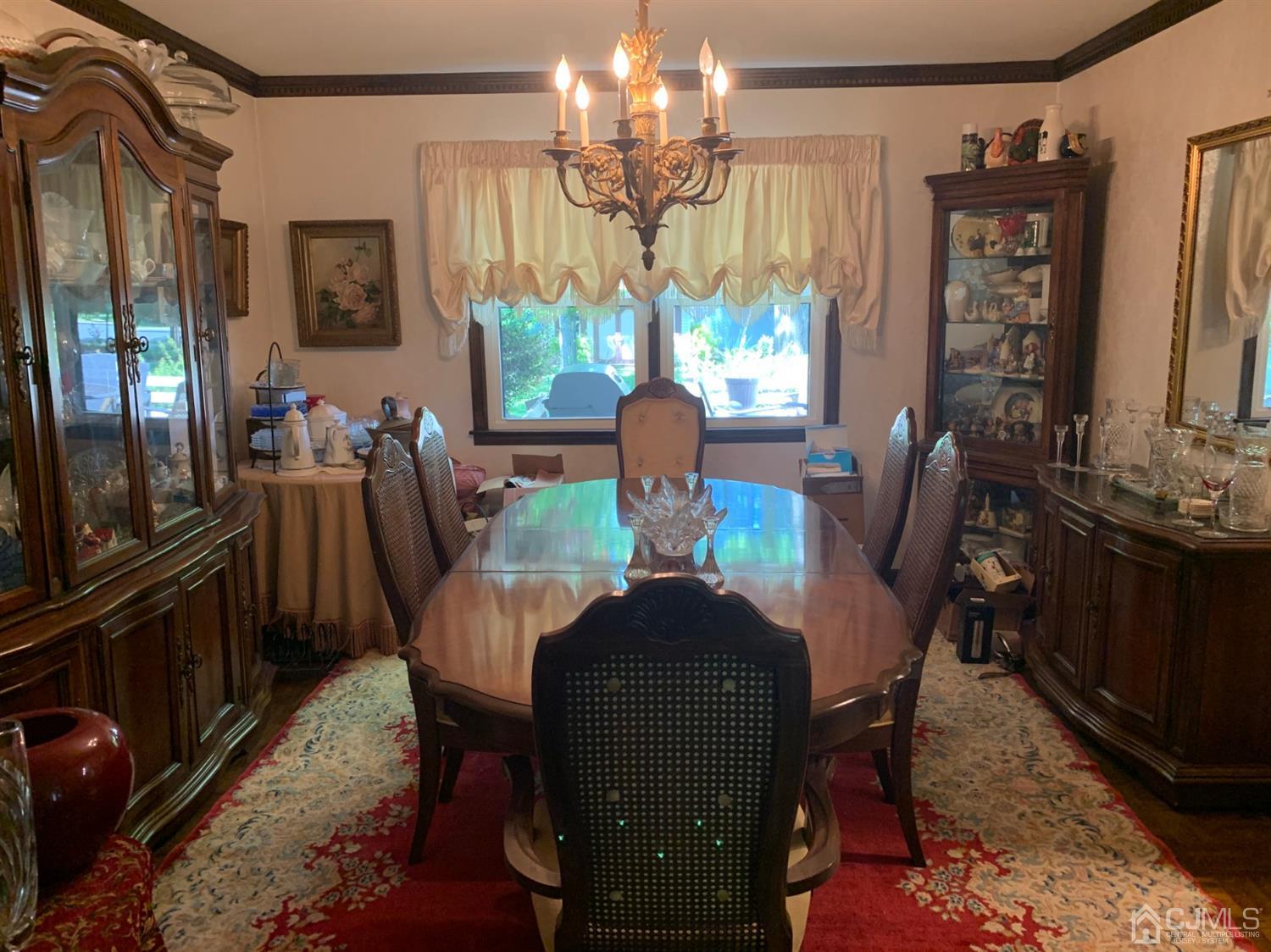 2 Fox Hill Road Edison, NJ 08820 - Photo 21 of 37 a view of a dining room with furniture a chandelier and window