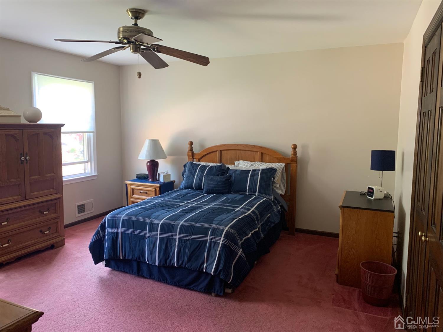 2 Fox Hill Road Edison, NJ 08820 - Photo 24 of 37 a bedroom with a bed and a chandelier