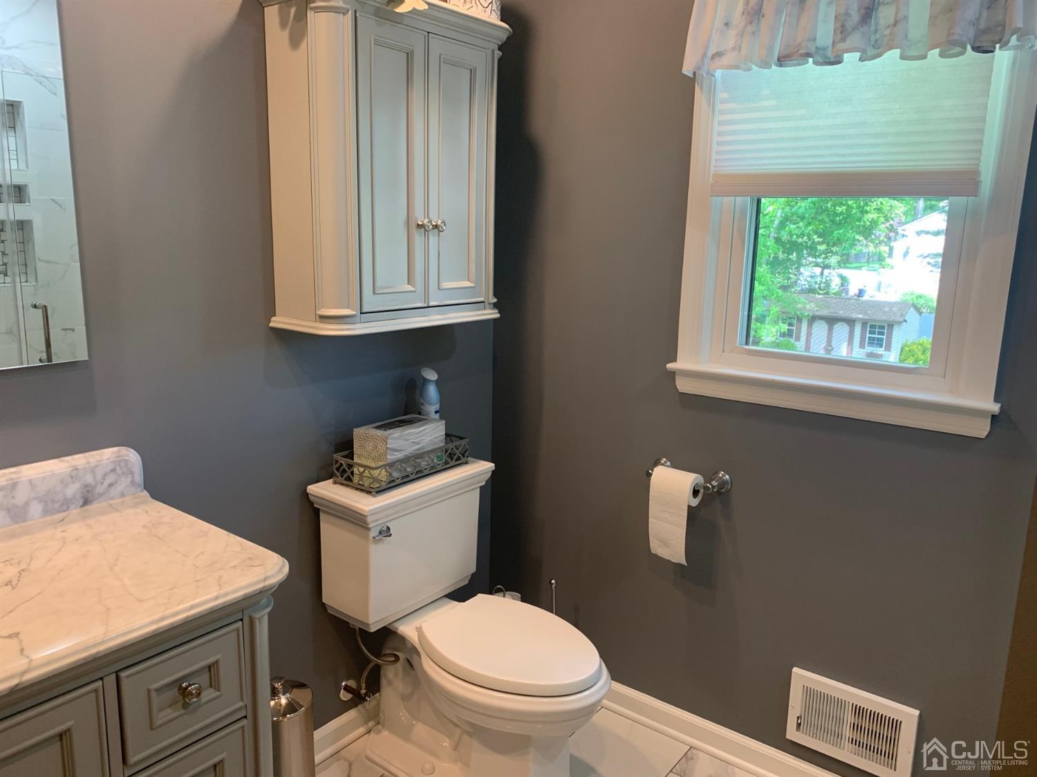 2 Fox Hill Road Edison, NJ 08820 - Photo 29 of 37 a bathroom with a toilet a sink and a window