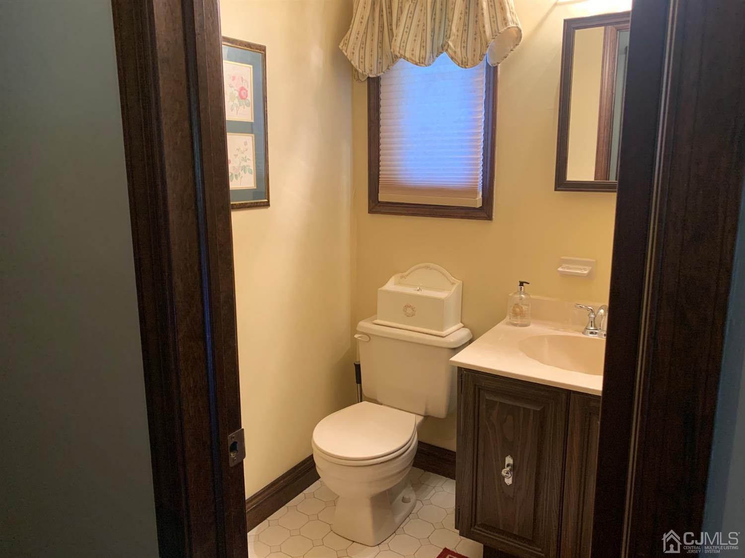 2 Fox Hill Road Edison, NJ 08820 - Photo 33 of 37 a bathroom with a toilet a sink and mirror