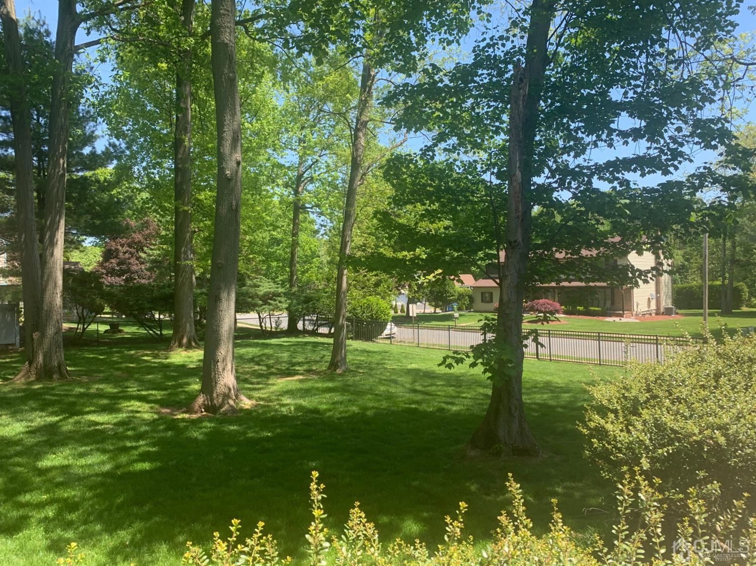2 Fox Hill Road Edison, NJ 08820 - Photo 6 of 37 a large yard with lots of green space and trees in the background