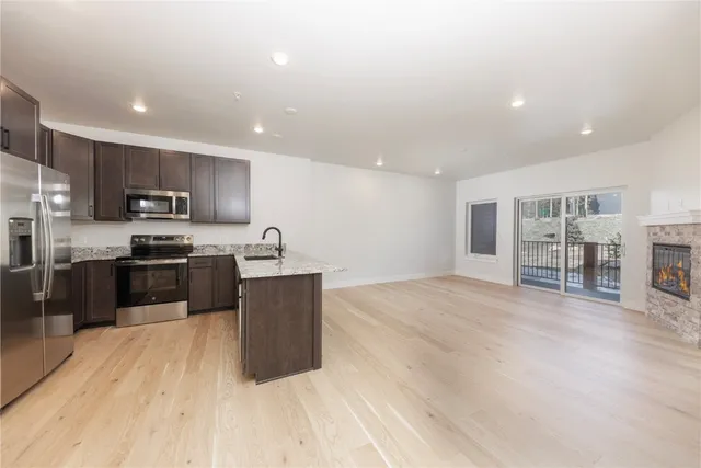 a view of an empty room with a fireplace