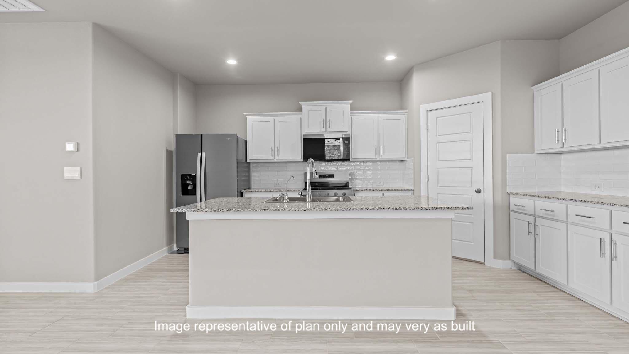 2902 134th Street Lubbock, TX 79423 - Photo 5 of 30 a kitchen with kitchen island a sink stainless steel appliances and white cabinets
