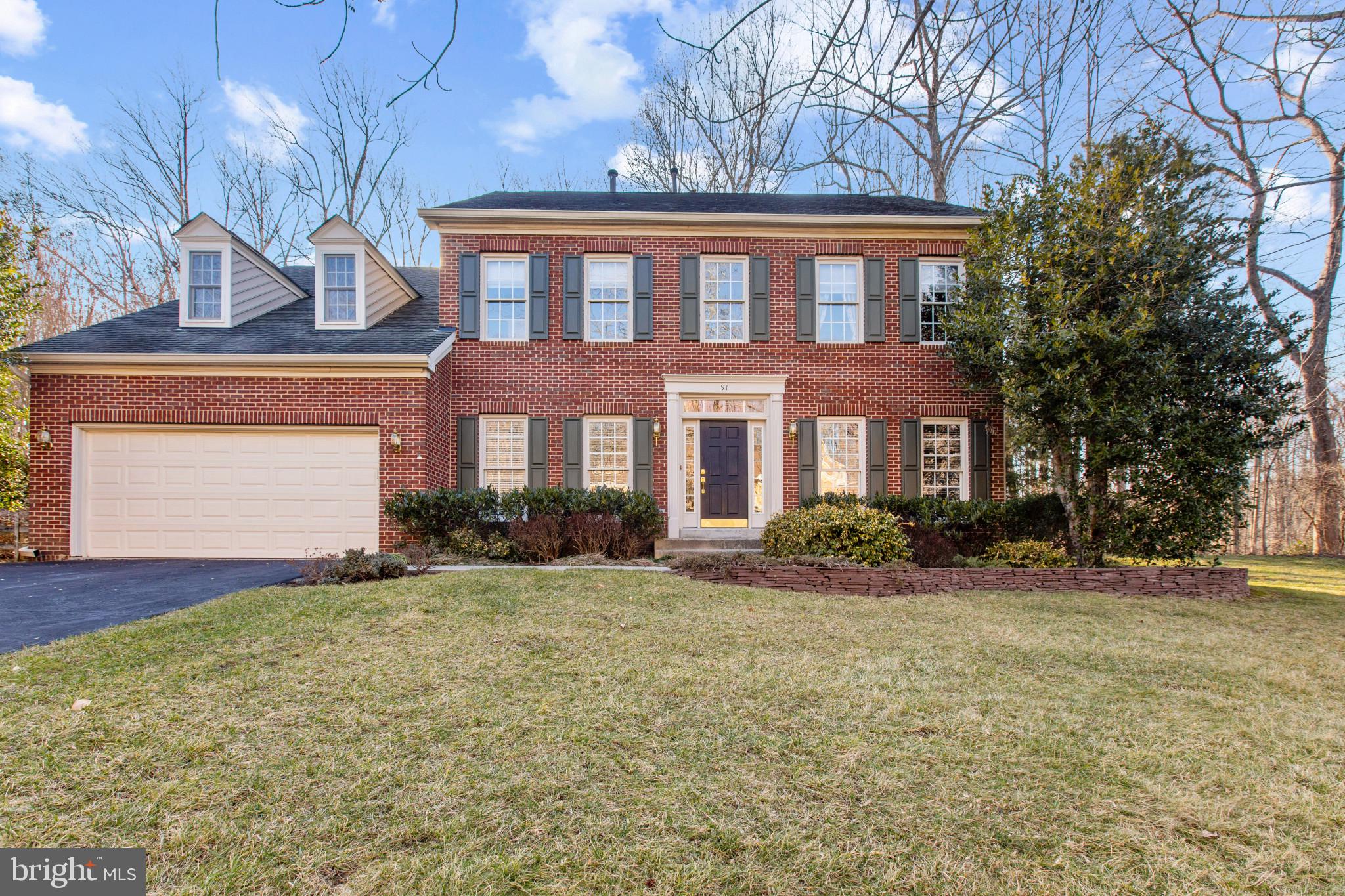 91 Colony Crossing Edgewater, MD 21037 - Photo 1 of 38 a front view of a house with a yard and garage