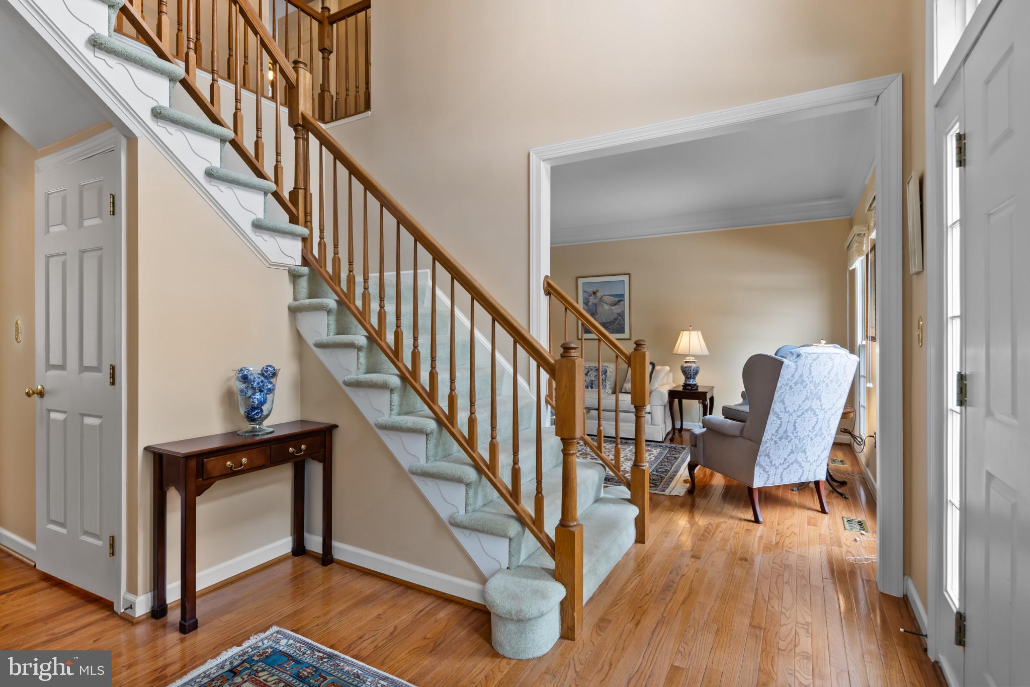 91 Colony Crossing Edgewater, MD 21037 - Photo 3 of 38 a view of a hallway with wooden floor and stairs