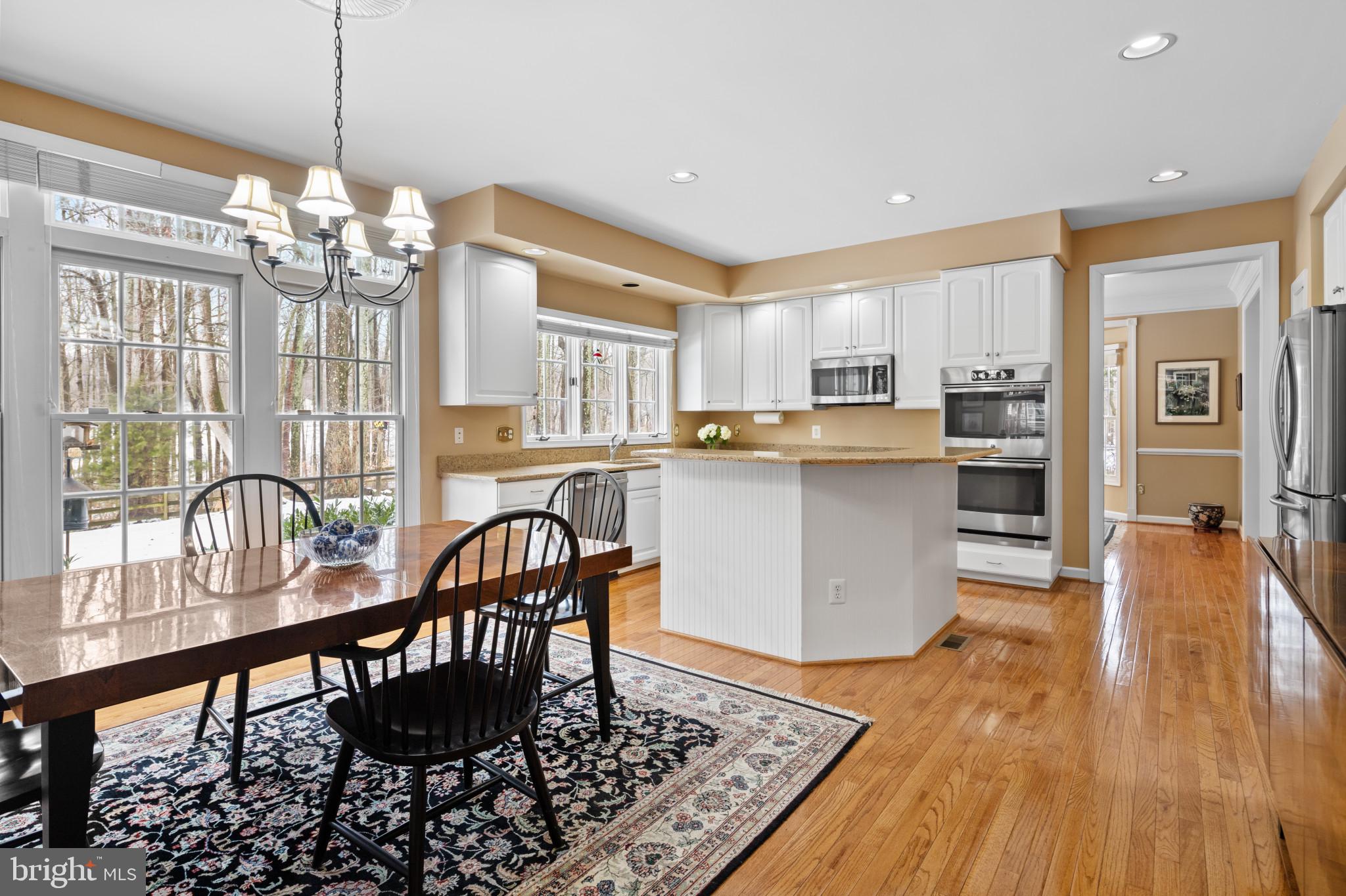 91 Colony Crossing Edgewater, MD 21037 - Photo 7 of 38 a view of a dining room with furniture a chandelier and wooden floor