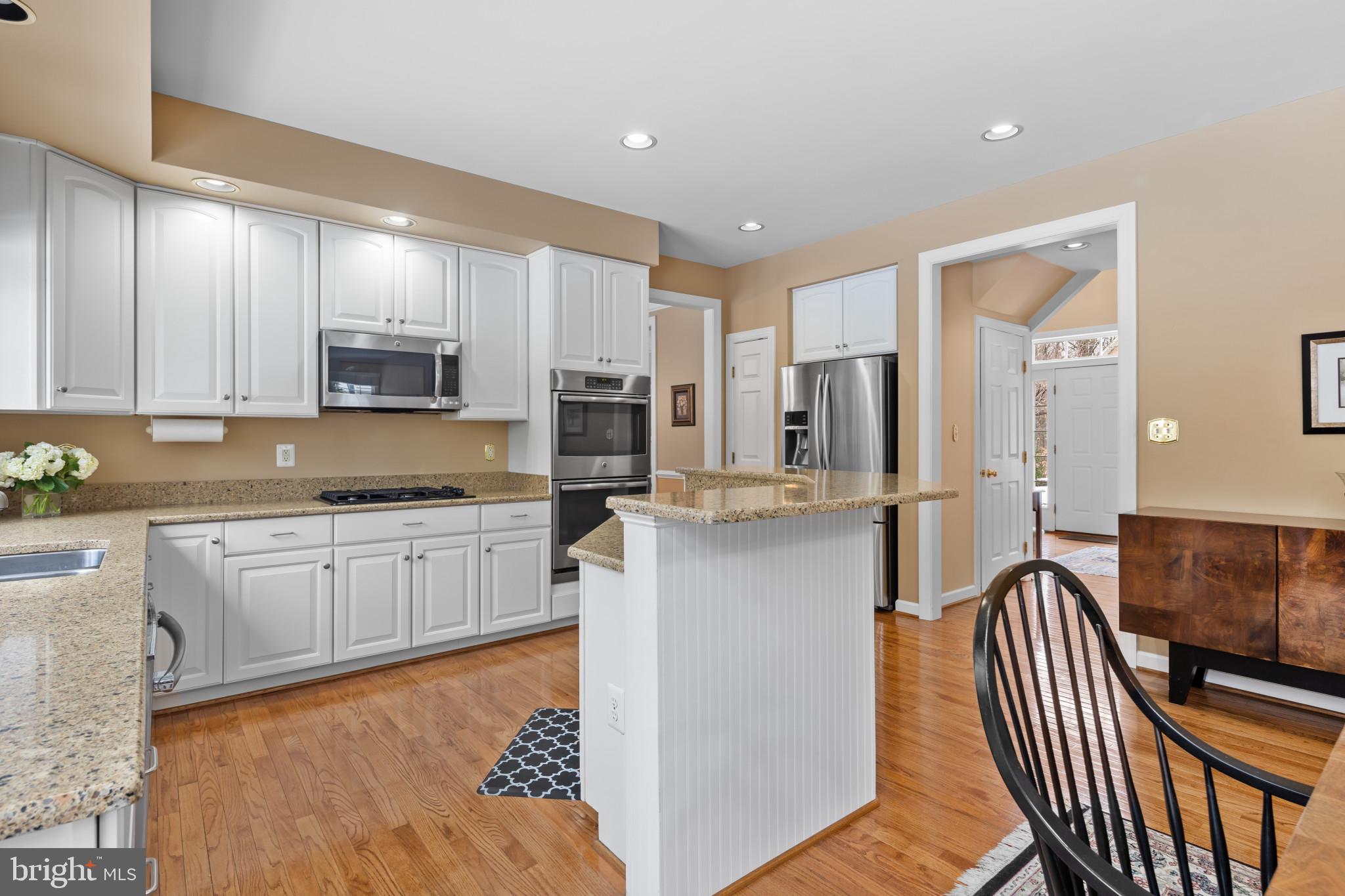 91 Colony Crossing Edgewater, MD 21037 - Photo 9 of 38 a kitchen with stainless steel appliances granite countertop a refrigerator a stove top oven a sink and dishwasher