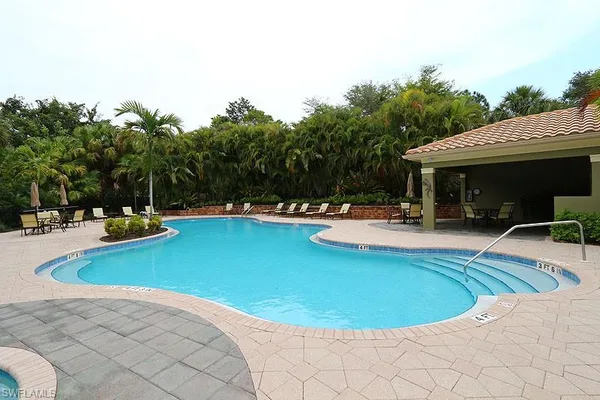 a view of a swimming pool with chairs