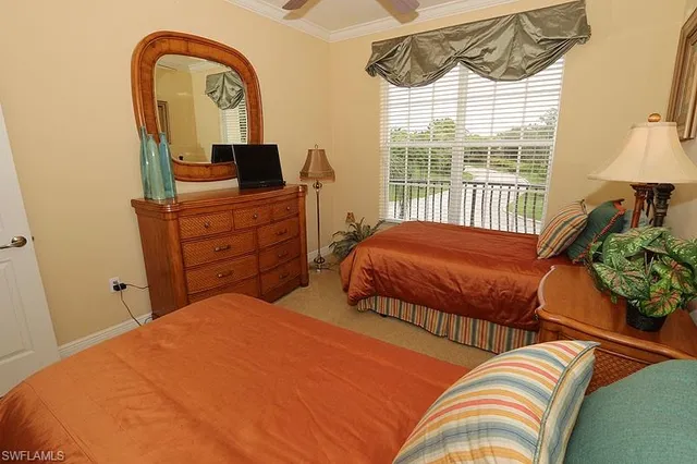 a bedroom with two beds and a window