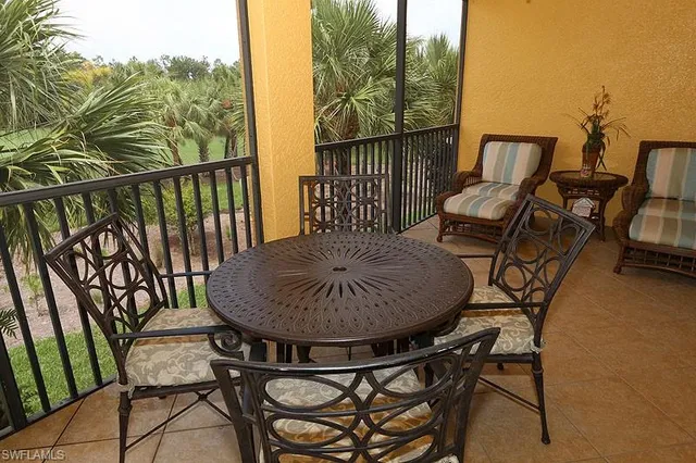 a view of a chairs and table in the balcony