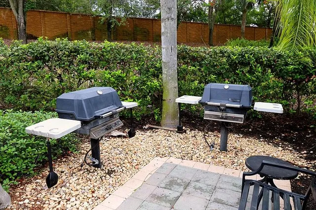 a wooden bench sitting in the middle of a backyard