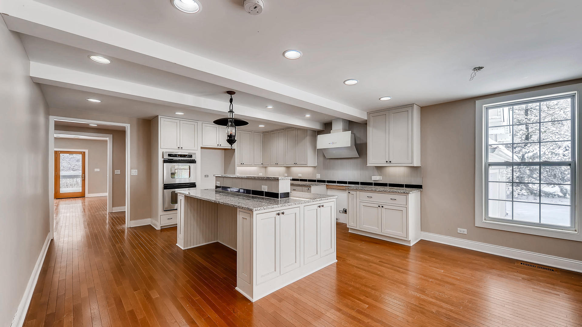 270 Country Commons Road Cary, IL 60013 - Photo 13 of 39 a kitchen with stainless steel appliances granite countertop wooden floors and white cabinets