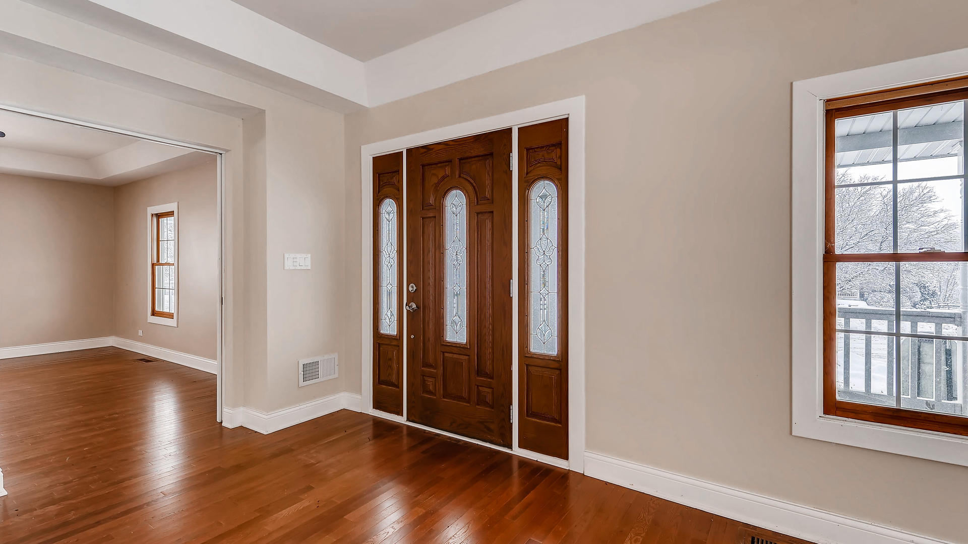 270 Country Commons Road Cary, IL 60013 - Photo 3 of 39 an empty room with wooden floor and windows