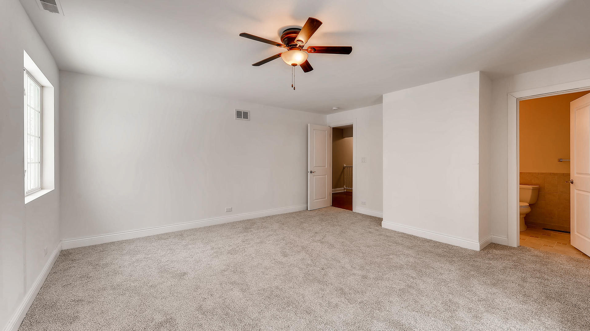 270 Country Commons Road Cary, IL 60013 - Photo 30 of 39 an empty room with ceiling fan and window