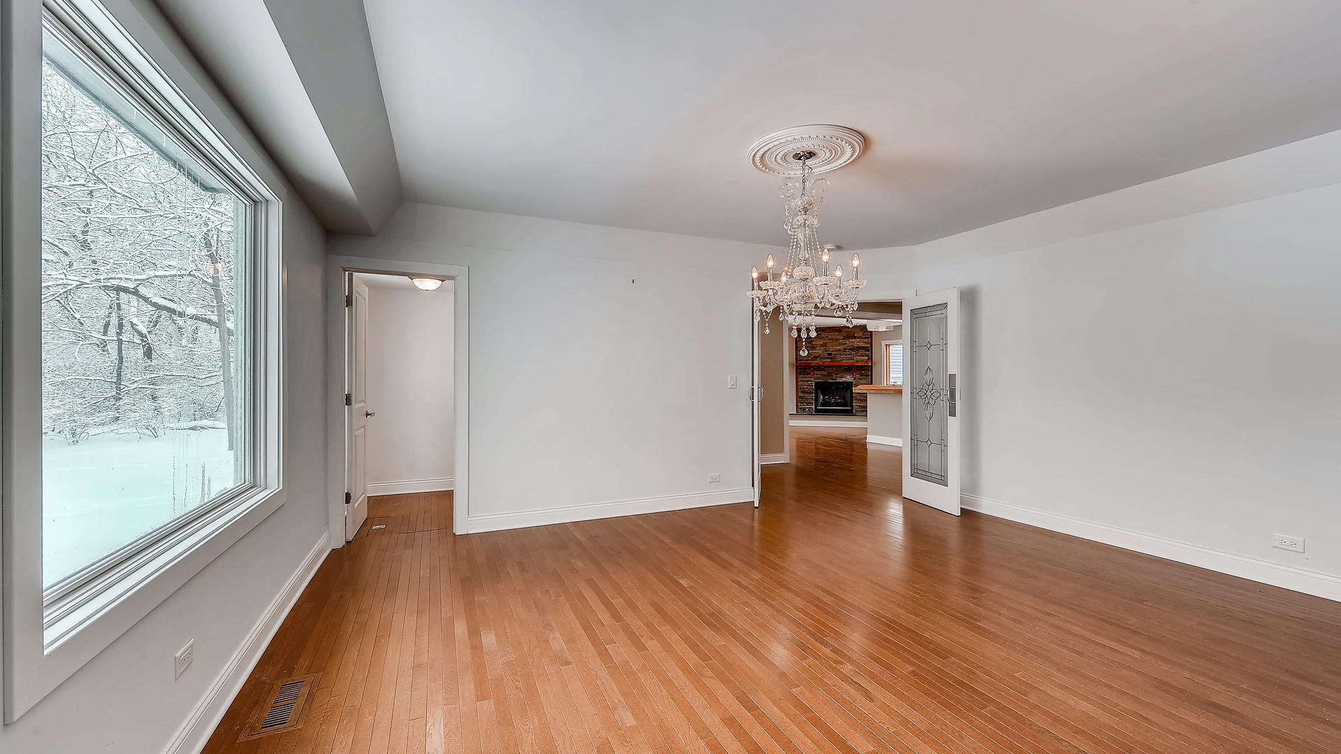 270 Country Commons Road Cary, IL 60013 - Photo 7 of 39 a view of an empty room with wooden floor and a window