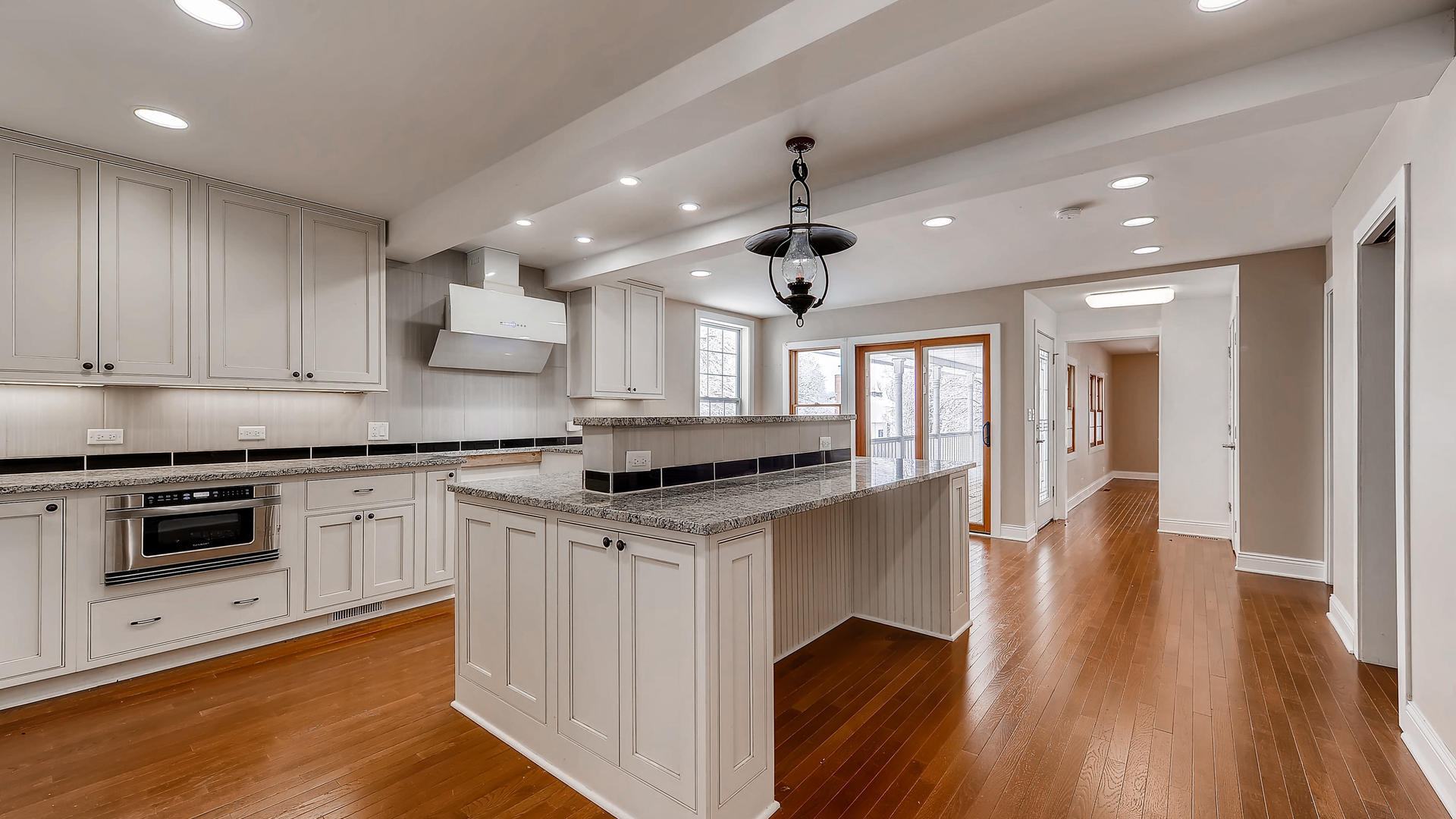 270 Country Commons Road Cary, IL 60013 - Photo 10 of 39 a kitchen with granite countertop a stove and a wooden floors