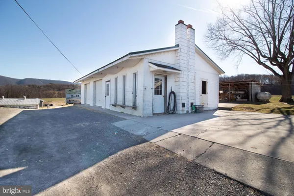 a view of a backyard with wooden fence