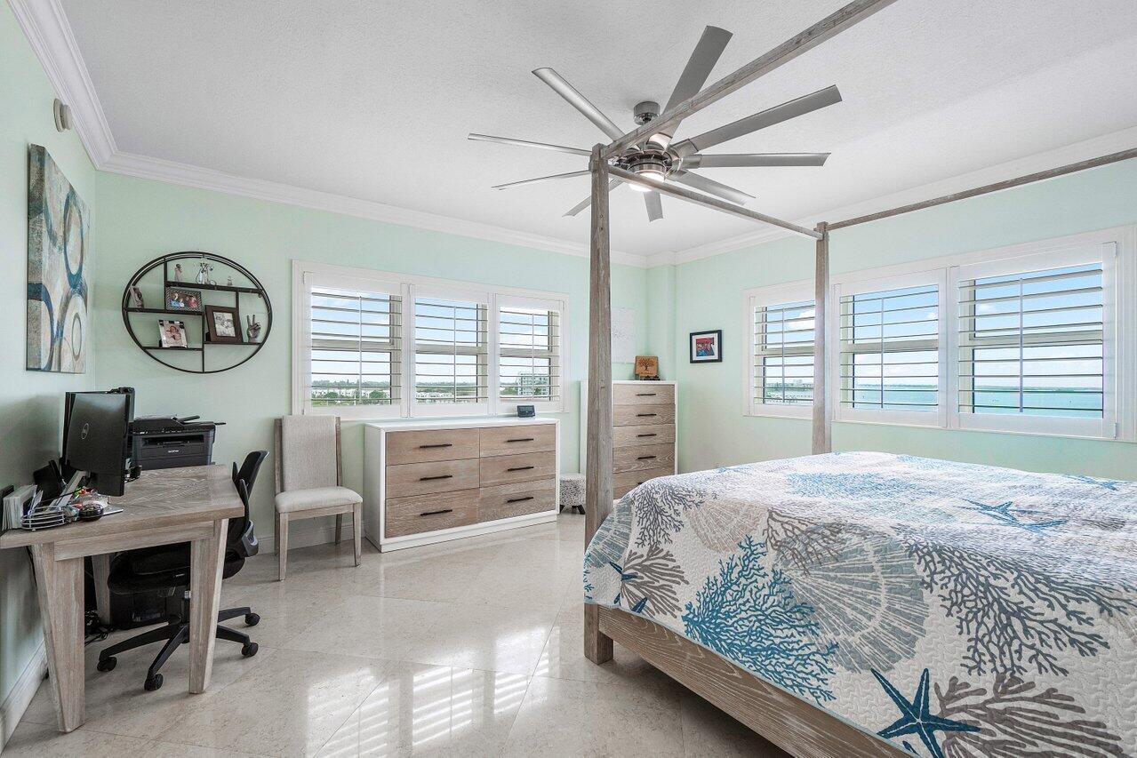 2650 Lake Shore Drive, Unit 701 Riviera Beach, FL 33404 - Photo 18 of 64 a bedroom with a large bed and a window