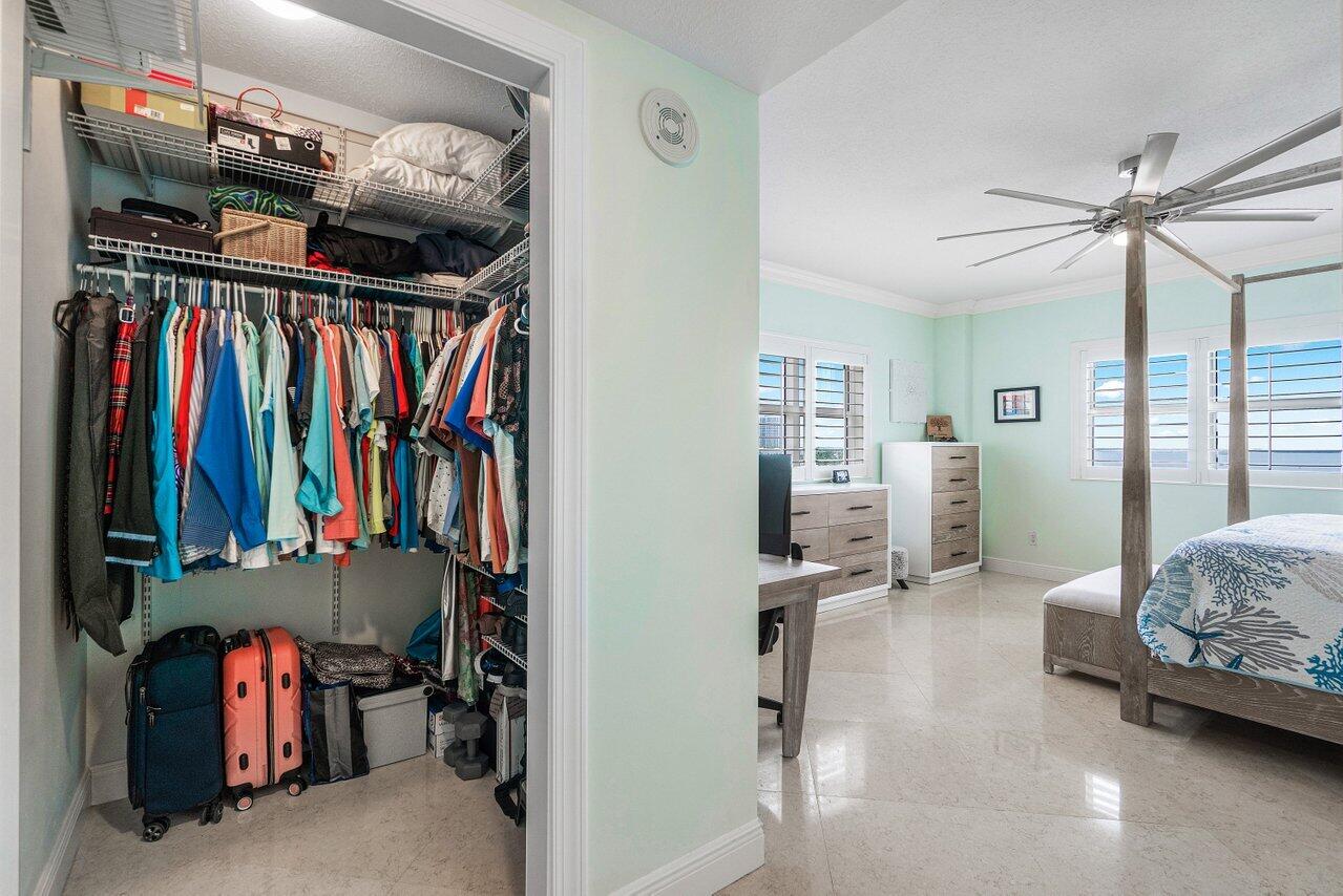 2650 Lake Shore Drive, Unit 701 Riviera Beach, FL 33404 - Photo 20 of 64 a view of walk in closet with clothes and shoes
