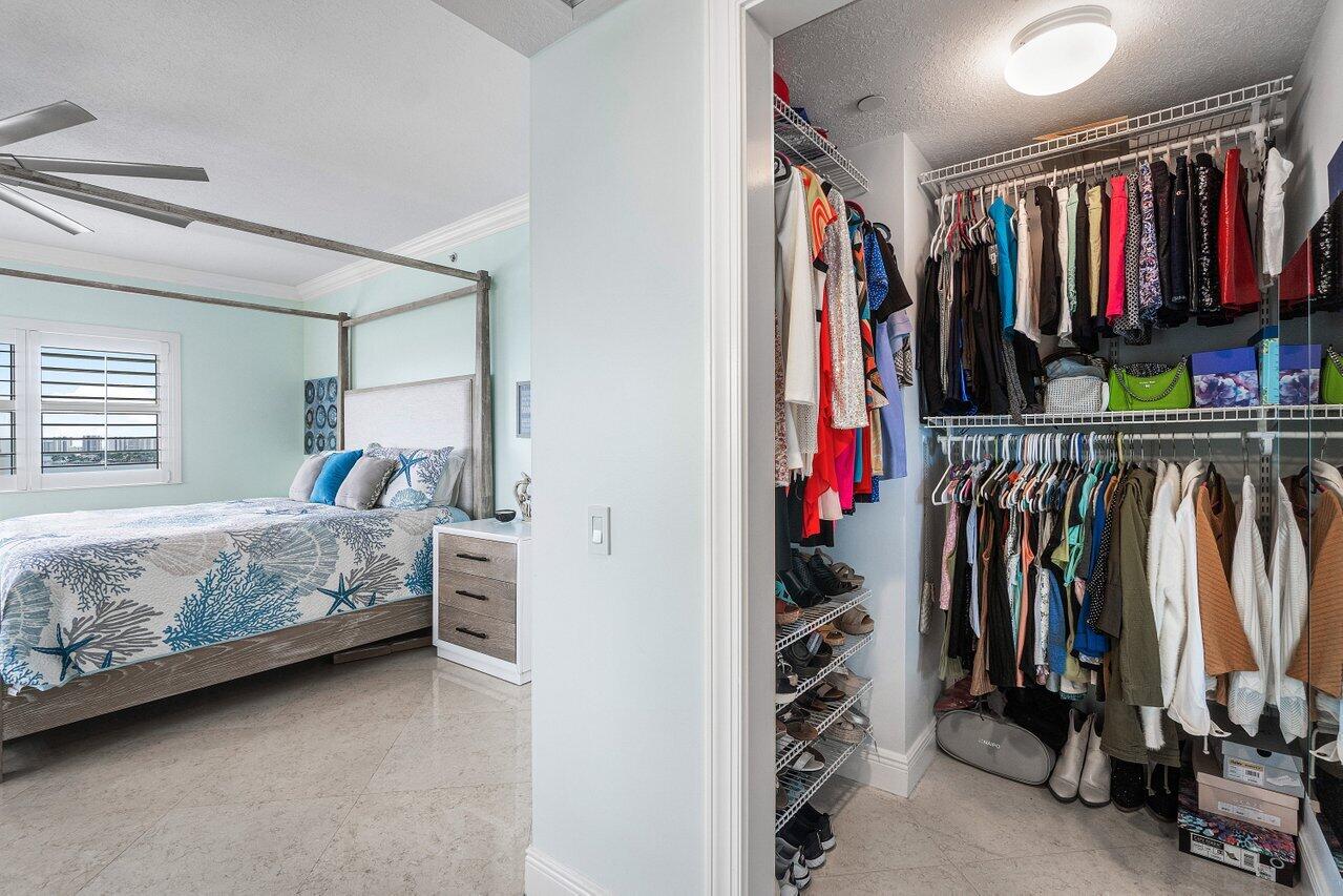 2650 Lake Shore Drive, Unit 701 Riviera Beach, FL 33404 - Photo 21 of 64 a view of walk in closet with clothes and shoes