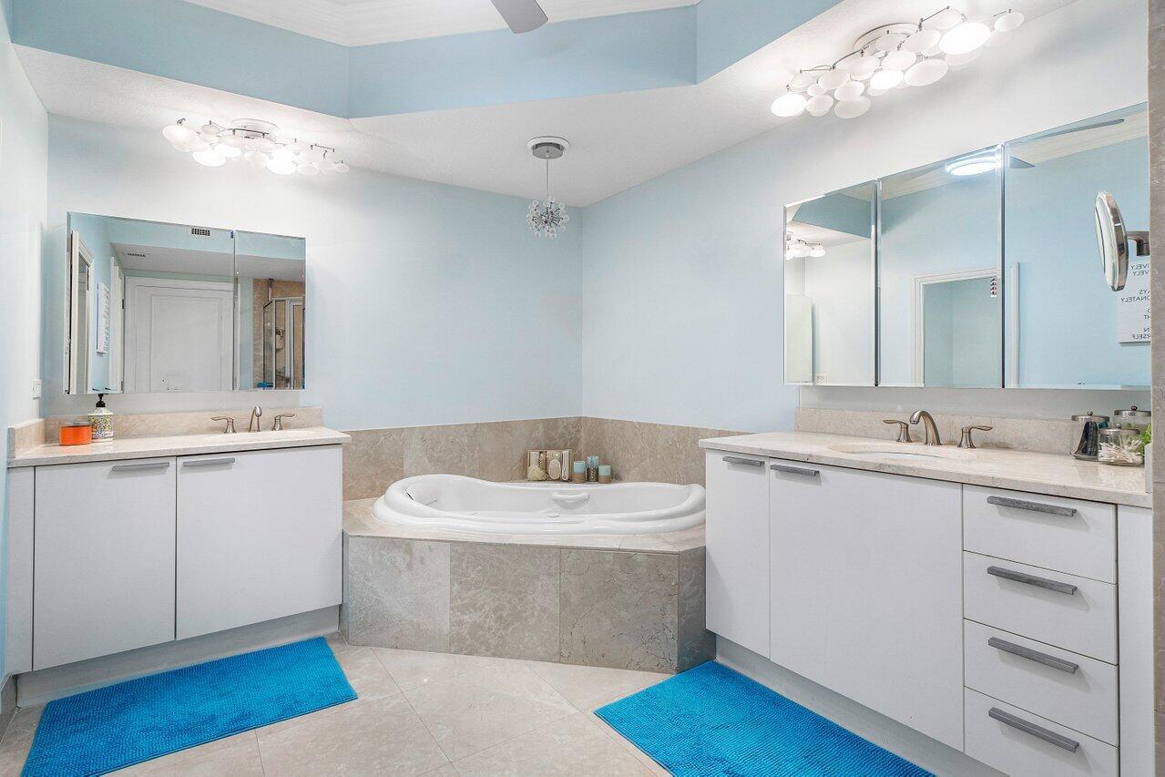 2650 Lake Shore Drive, Unit 701 Riviera Beach, FL 33404 - Photo 23 of 64 a bathroom with a sink vanity and mirror