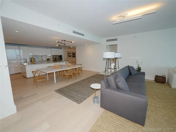 a living room with furniture and a lamp