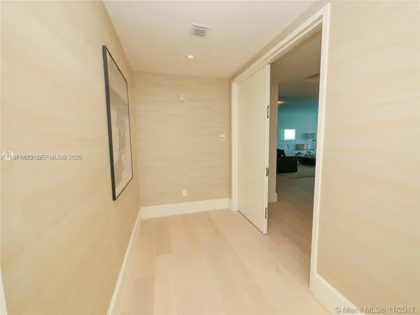 a living room with furniture and floor to ceiling window