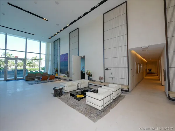 a living room with couches and painted walls next to a window