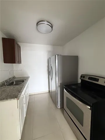 a view of an empty room with a sink