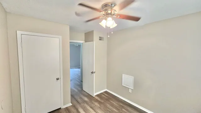 a view of a hallway with a chandelier fan