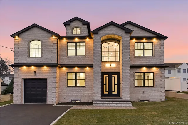 a front view of a house with a yard
