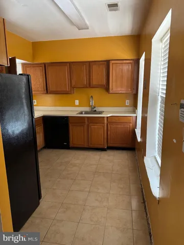 a large bathroom with a tub sink and mirror