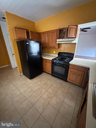 a kitchen with granite countertop a refrigerator and a stove