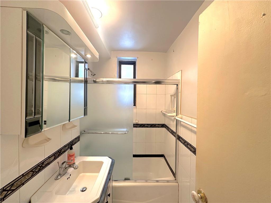 3060 Ocean Avenue, Unit 2C Brooklyn, NY 11235 - Photo 11 of 20 a bathroom with a sink and a mirror