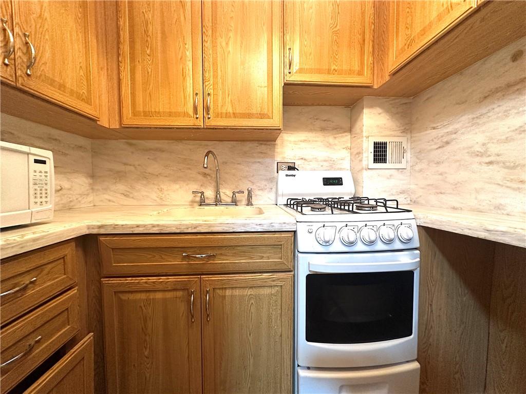 3060 Ocean Avenue, Unit 2C Brooklyn, NY 11235 - Photo 14 of 20 a stove top oven sitting inside of a kitchen