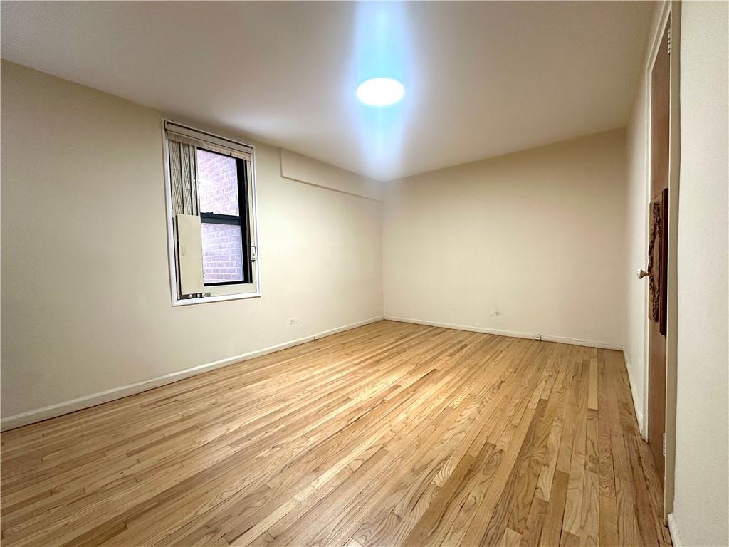 3060 Ocean Avenue, Unit 2C Brooklyn, NY 11235 - Photo 9 of 20 a view of empty room with wooden floor and fan