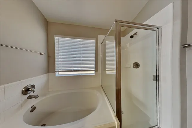 a bathroom with a tub and a shower