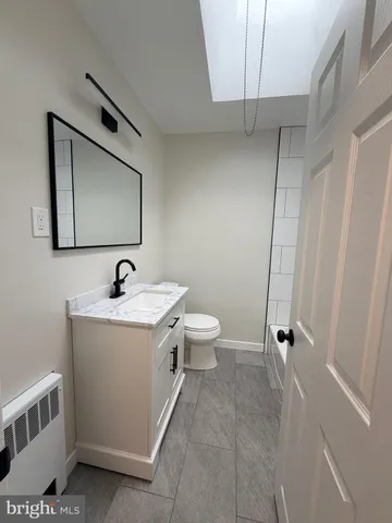 a view of bathroom with a sink and mirror