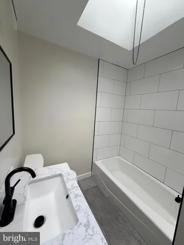 a bathroom with a tub and sink
