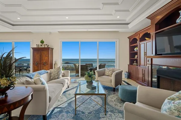 a dining room with furniture and a floor to ceiling window