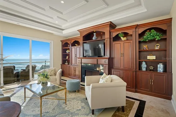 a living room with furniture and a floor to ceiling window