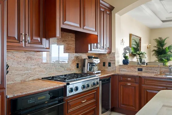 a bathroom with a granite countertop sink a toilet and shower