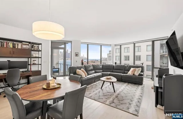 a living room with furniture a rug and a flat screen tv