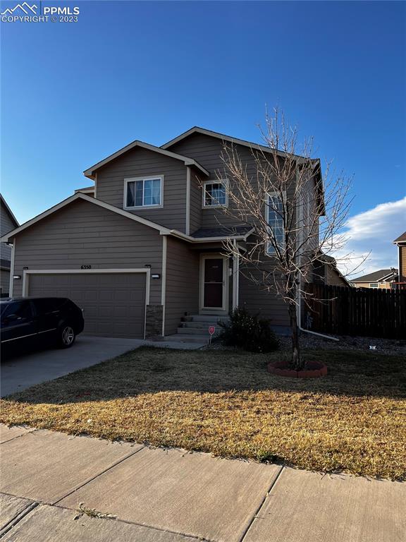 a view of a house with a yard