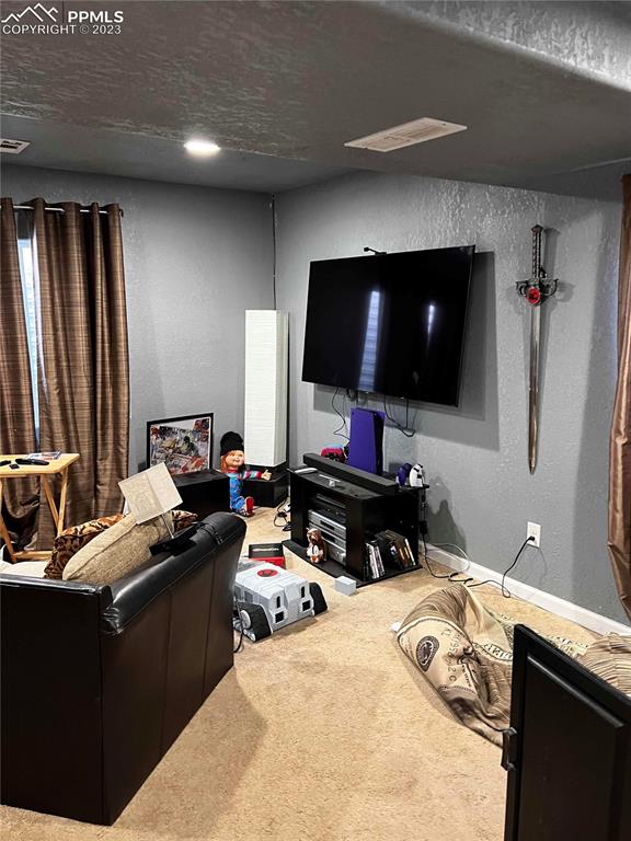 6350 Dancing Moon Way Colorado Springs, CO 80911 - Photo 7 of 12 a bedroom with a bed and a flat screen tv